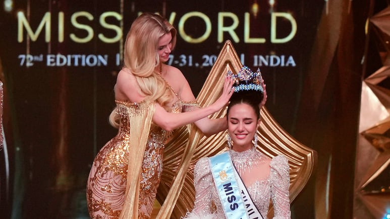 Krystyna Pyszkova of Czech Republic, left, crowns her successor Opal Suchata of Thailand after she who won the 72nd Miss World pageant in Hyderabad, India, Saturday, May 31, 2025. (AP Photo/Mahesh Kumar A.)